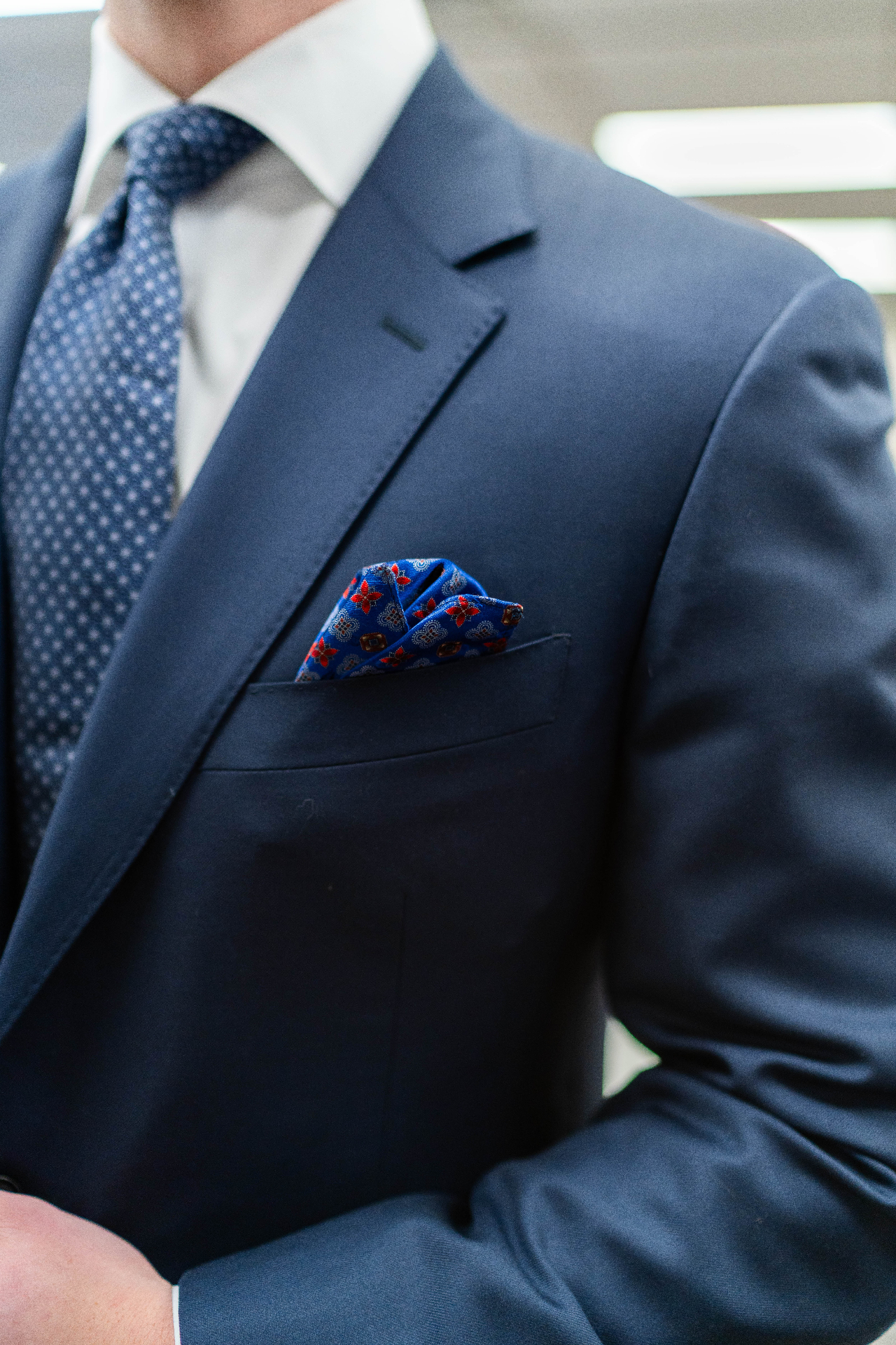 Pocket square detail on navy suit